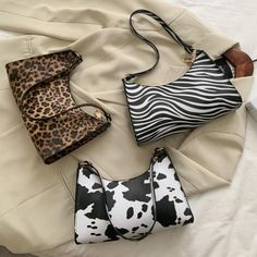 Unleash your wild side with our Animal Print Shoulder Bag! Featuring cow, leopard, and zebra prints, this medium-sized shoulder bag is the perfect accessory for any occasion. Don't be afraid to stand out from the crowd and show off your ferocious style. Tapping into your inner animal has never been so stylish and functional! 🐄🐆🦓 Description: Style: Shoulder Bag Fabric: PU Lining: Synthetic Leather Bag Shape: Horizontal Square Bag Trend Style: Underarm Bag Opening Method: Zipper Strap Number: Zebra Handbag, Plaid Handbag, Trendy Luggage, Leopard Handbag, Retro Shoulder Bag, China Products, Faux Leather Handbag, Striped Bags, Purse Fashion