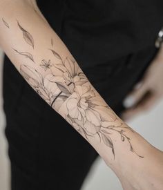 a woman with a flower tattoo on her arm