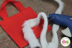 a red bag with white feathers and a blue blow dryer