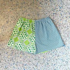 "Up cycled, repurposed, vintage fabric. Green and Blue Strawberry Print, mixed with a Blue and White print Size: XL Waist 31\" stretches to 52\"  Hips 54\"  Rise 14.5\" Inseam 4.5\" High waisted fit, contrasting side seam pockets. Elastic waist band .  Cotton, poly .  *fabric is repurposed may have slight wear . Each of these shorts are one of a kind with unique placement of fabric and colors.         From the Kiki42 label, handmade in Los Angeles CA." Green Cotton Bottoms For Daywear, Summer Green Shorts With Patchwork, Upcycled Blue Bottoms For Spring, Blue Cotton Patchwork Shorts, Patchwork Cotton Shorts For Vacation, Green Cotton Retro Shorts, Green Retro Cotton Shorts, Cotton Patchwork Shorts For Vacation, Blue Cotton Upcycled Bottoms