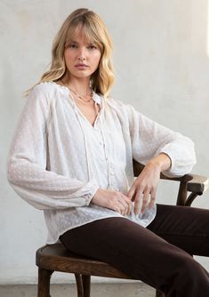 Light-as-air swiss dot chiffon adds an ethereal quality to this classic bohemian blouse. Inspired by some of our favorite vintage pieces, this effortless style features lace trim inserts, a self-covered button front, and playful tassel ties. FINAL SALE Swiss dot chiffon Relaxed fit Long voluminous sleeve Elastic wrist cuff Ruffled neck V-neckline with tassel ties Self-covered button front Lace trim inserts Sheer Removable lining Dreamy bohemian peasant blouse Model is 5'9, wearing a size S.Style Affordable Relaxed Fit V-neck Blouse, Casual Swiss Dot Blouse For Fall, Fall Flowy Blouse With Lace Trim, Flowy Lace Trim Blouse For Fall, White Swiss Dot Top For Fall, Feminine Blouse With Lace Trim For Layering, Casual Swiss Dot Blouse For Daywear, Elegant Swiss Dot Top For Daywear, Feminine Long Sleeve Blouse With Swiss Dot