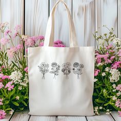 If you're looking for a custom tote bag, then our personalized birth flower tote bag is perfect for you! This high-quality tote bag can be customized with birth flowers in a beautiful simplistic design! This custom birth flower tote bag would make the perfect Mother's Day gift, birthday gift, best friends gift, Christmas gift, or to be given as a bridal party gift. Pick up your personalized birth flower tote today! DESCRIPTION -100% cotton canvas -Heavy fabric (12 oz/yd² (406.9 g/m -Natural colo Mom Best Friend, Flower Tote Bag, Flower Tote, Custom Tote Bags, Personalized Tote Bags, Simplistic Design, Best Friend Gift, Birth Flower, Bridal Party Gifts