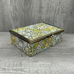 a decorative box sitting on top of a wooden table