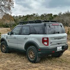 an suv parked in the middle of a field