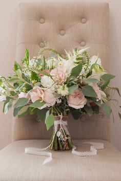 a bouquet of flowers sitting on top of a chair