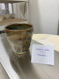 a note that is sitting on top of a table next to a bowl with writing on it