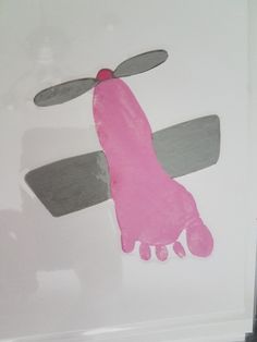 a pink and gray handprint on a white wall