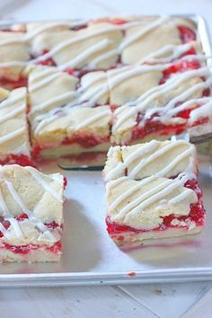 strawberry shortcakes with white icing on a tray