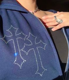 THIS IS MY OWN COPYRIGHTED DESIGN!! CHANNELLY'S BOUTIQUE IS THE ORIGINAL AND *ONLY* SELLER OF THIS HANDMADE ITEM. PLEASE DO NOT SUPPORT SHOPS THAT STEAL ARTWORK FROM SMALL ARTISTS/BUSINESSES.  Custom rhinestone cross hoodie in NAVY BLUE  This is for a navy blue version of the cyber cross hoodie. Some photos are from the black hoodie to demonstrate the rhinestone design. However, you WILL be receiving a NAVY BLUE hoodie. The shade of navy blue may vary due to various device settings and camera saturation. ⚠️READ DESCRIPTION FULLY️ The hoodie has 3 crosses on the hood. 1 cross on back of the jacket. 2 crosses on chest, 1 above pocket, and 1 cross on each sleeve. Made-to-order listing PRICE BREAKDOWN: 500+ rhinestones Men's/UNISEX Gildan Hoodie String skulls Heat transfer tape Priority mail s Rhinestone Clothes Aesthetic, Fall Rhinestone Hooded Hoodie, Fall Rhinestone Hoodie, Fall Hoodie With Rhinestones, Rhinestone Hooded Hoodie For Streetwear, Hooded Rhinestone Hoodie For Streetwear, Rhinestone Hoodie For Streetwear, Streetwear Hoodie With Rhinestones, Winter Hoodie With Rhinestones