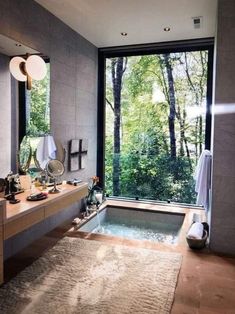 a bathroom with a large window and a jacuzzi tub in the middle of it