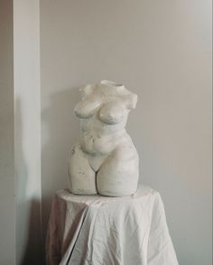 a white sculpture sitting on top of a table