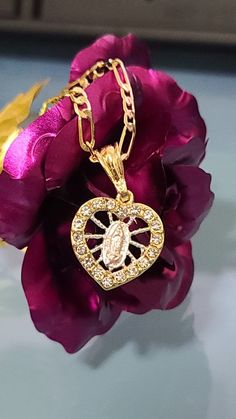 "14k Gold Plated Guadalupe Virgin & Heart 24\" Necklace \"Cadena de la Virgen de Guadalupe en Oro Laminado - Chapa de Oro- perfect for Gift! - Valentine's day, Mother's day, Chritmas. Material: Copper Measurements: Chain - 12 inch. from top to bottom (24\" Long from end to end) Virgin of Guadalupe According to tradition, Mary appeared to Juan Diego, who was an Aztec convert to Christianity, on December 9 and again on December 12, 1531. During her first apparition, she requested that a shrine Heart-shaped Miraculous Medal Jewelry Gift, Heart Shaped Miraculous Medal Jewelry Gift, St Jude Necklace, Mary Virgin, Juan Diego, Virgin Of Guadalupe, Necklace Heart, December 12, Tiffany Heart