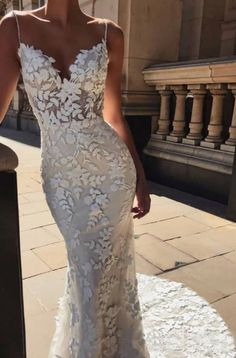 a woman in a white wedding dress standing outside