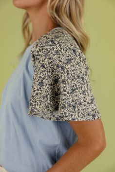 I love a little detail in my wardrobe and this blouse fits the bill! Featuring a dusty blue color and floral sleeves, the To The Lakes Detail Blouse is simple and beautiful. unlined Blue Cotton Tops With Floral Patchwork, Blue Floral Print Crew Neck Blouse, Blue Floral Print Tops For Daywear, Dusty Blue Color, Floral Sleeves, Blouse Fits, Floral Sleeve, The Bill, Skirt Jumpsuit