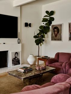 a living room filled with furniture and a flat screen tv mounted on the wall above a fireplace