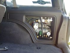 the inside of a car with an air conditioner and gauges in it's trunk