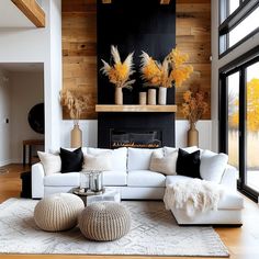 a living room filled with furniture and a fire place next to a wall mounted fireplace