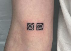 a couple of square tattoos on the wrist