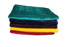 four different colored blankets stacked on top of each other