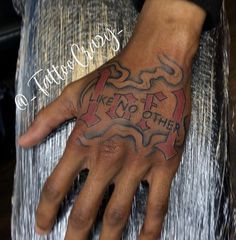 a man with a tattoo on his hand and some writing on the palm is shown