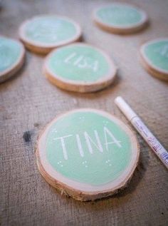 some green and white painted wood slices with the word tuna written on them next to a marker