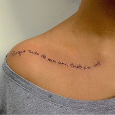 the back of a woman's neck with an inscription written in cursive writing