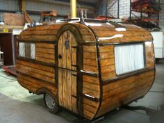 a small wooden trailer parked in a garage