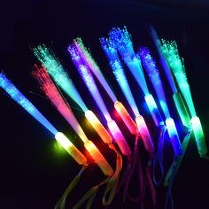 several different colored toothbrushes in the dark with light up wires attached to them