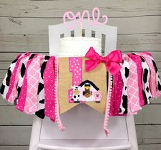 a pink and black cowgirl baby blanket on top of a white chair with the word monogrammed