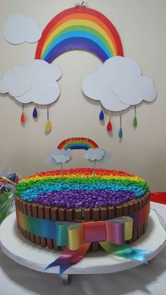 a cake with rainbow icing and decorations on it