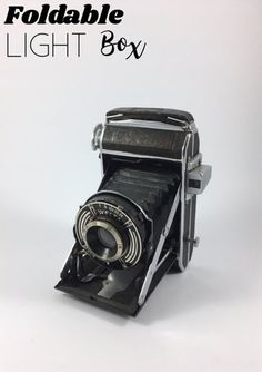 an old fashioned camera with the words foldable light box