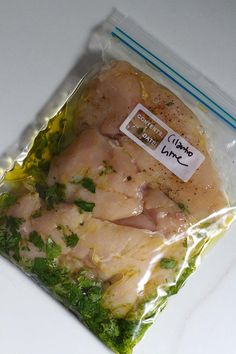 the chicken is wrapped in plastic and ready to be cooked