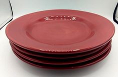 four red plates stacked on top of each other