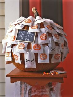 a decorated pumpkin sitting on top of a wooden table