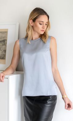 Meet the perfect silk shell top. This elevated silk tank can be worn alone or under your favorite blazer – you'll look equally fabulous either way. Elegant and classy with a versatile and minimalist silhouette. Wear on its own or pair with a blazer. Minimalist gold button and keyhole closure on the back. Hits just below the hips with side slits. Great tucked or untucked. 100% ULTRA-PREMIUM SATIN CHARMEUSE SILK – Washable Versatile Fitted Satin Tops, Fitted Satin Tops, Formal Satin Tank Top For Summer, Fitted Silk Tank Top For Work, Elegant Tank Top For Spring, Classic Sleeveless Top For Night Out, Elegant Fitted Tank Top For Summer, Elegant Fitted Summer Tank Top, Sleek Silk Spring Blouse