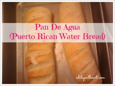 two loaves of bread sitting on top of a baking pan with the words pan de agua puerto rican water bread