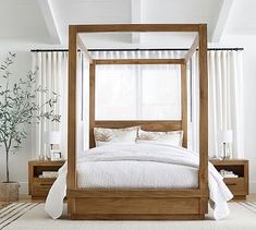 a bed with white sheets and pillows in a room