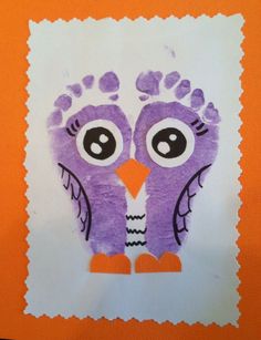 an orange and white paper with a purple owl drawn on it's face in the shape of a handprint