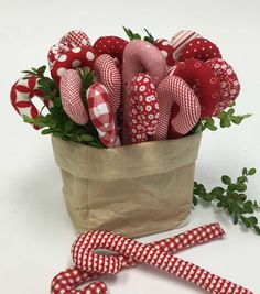 a paper bag filled with red and white candy canes on top of a table