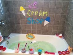 a child's bathtub with ice cream and toys in it