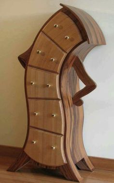 a wooden cabinet with many drawers on it