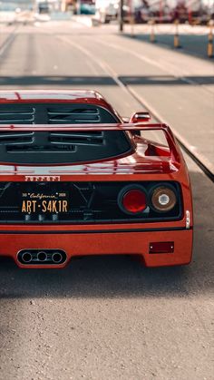 a red sports car parked on the side of the road