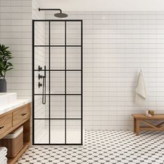 a bathroom with black and white tiles on the floor, shower stall and sink area