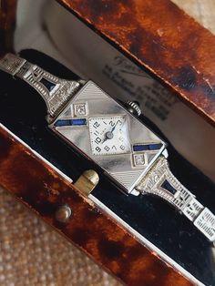 For your consideration is a women's fabulous antique cocktail wristwatch by Elgin Watch Company c. 1920s. The wristwatch is set with old cut diamonds and sapphires in solid 14k white gold, a fine millgrain etched border surrounds the precious stones, which are in very good antique condition  The wristwatch is fitted with a cabochon sapphire crown, which enables efficient winding as well as being aesthetically pleasing to the eye, the timekeeping is very good, the winding is smooth.  This wristwa Luxury Gold Art Deco Jewelry And Watches, Luxury Victorian Collectible Watch, Antique Platinum Evening Watches, Art Deco Platinum Evening Watches, Platinum Art Deco Evening Watches, Antique Diamond Watch For Evening, Vintage Platinum Watches For Evening, Antique Platinum Jewelry And Watches For Evening, Platinum Art Deco Watch For Formal Occasions