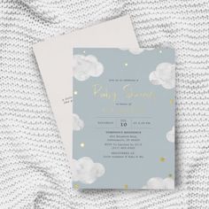 a baby shower is shown with clouds and stars on the front, in gold foil