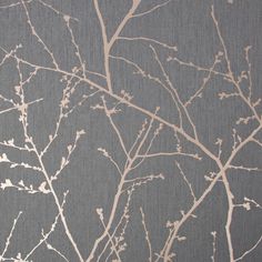 the branches of a tree against a gray background with white and light brown paint on it