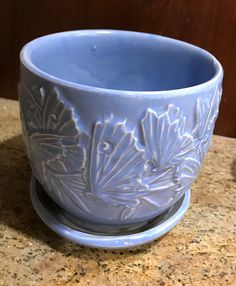 a blue cup sitting on top of a counter