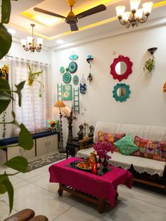 a living room filled with furniture and lots of decorations on the wall next to a window