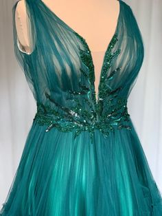 a green dress with sequins on it