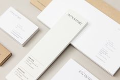 the stationery is laid out neatly on top of each other, including business cards and envelopes